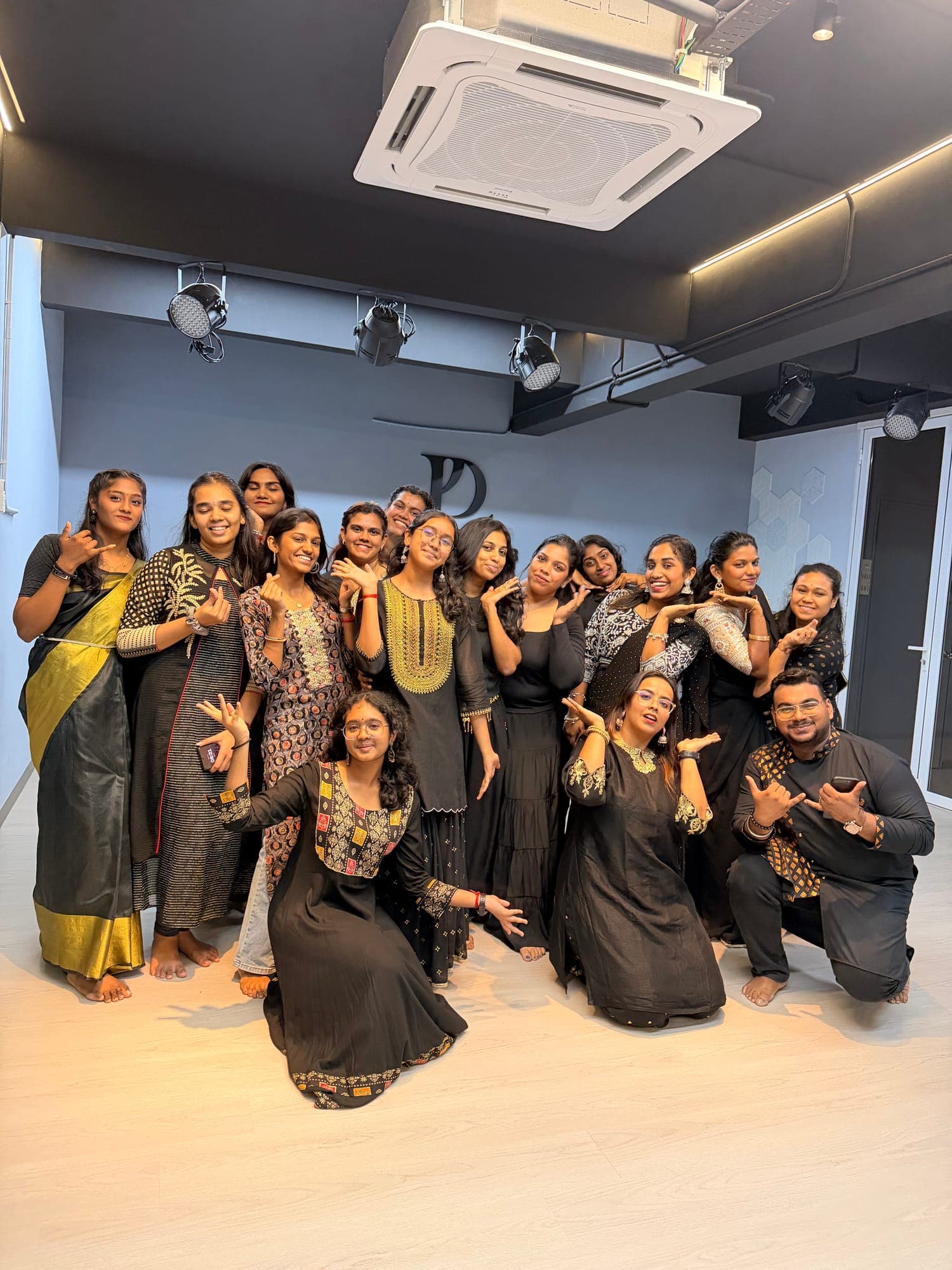 A group of My Dance Lab dancers in black and gold traditional outfits, posing together in the Alma studio